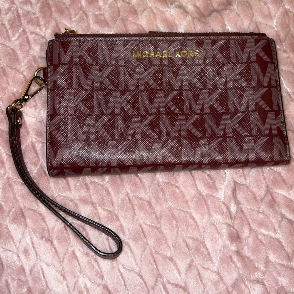 Burgundy Michael Kors wristlet wallet with phone case